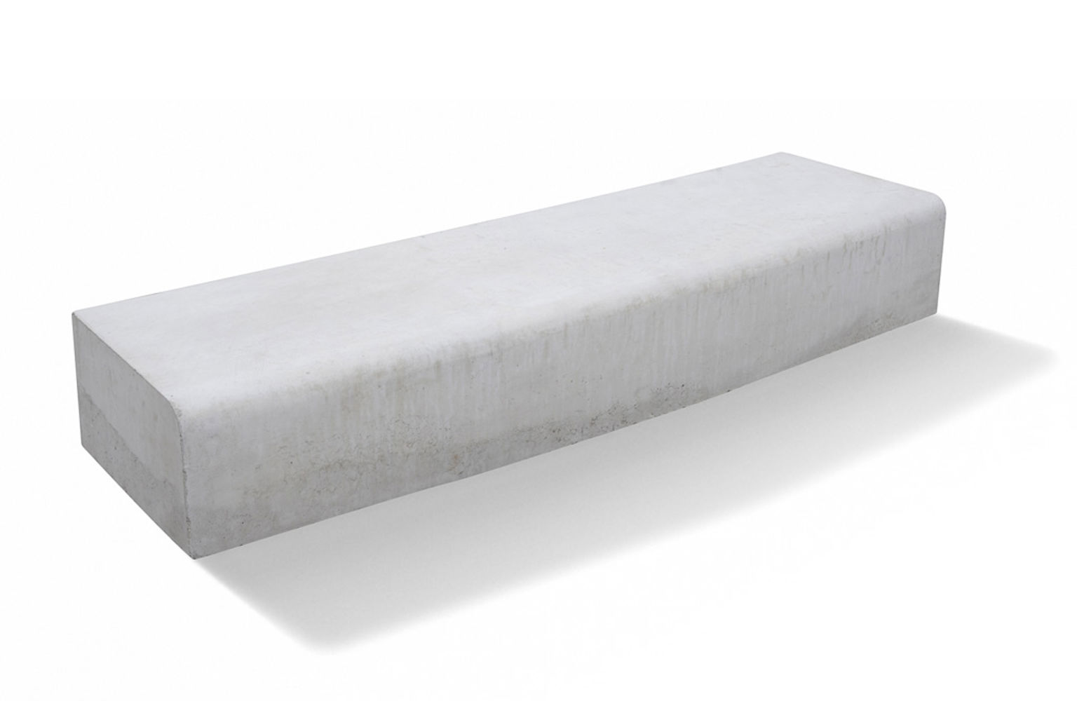 Bild på en kantsten i betong. Stenen är rektangulär och har en avrundad form som minimerar risken för fordonsskador.